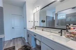 a bathroom with a double vanity sink and a mirror