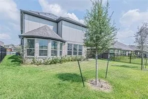 a view of a house with a backyard and a garden