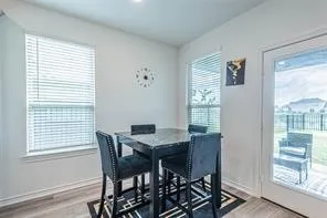 a view of a dining room with furniture wooden floor and a window