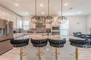 a kitchen with a table chairs stove and kitchen island