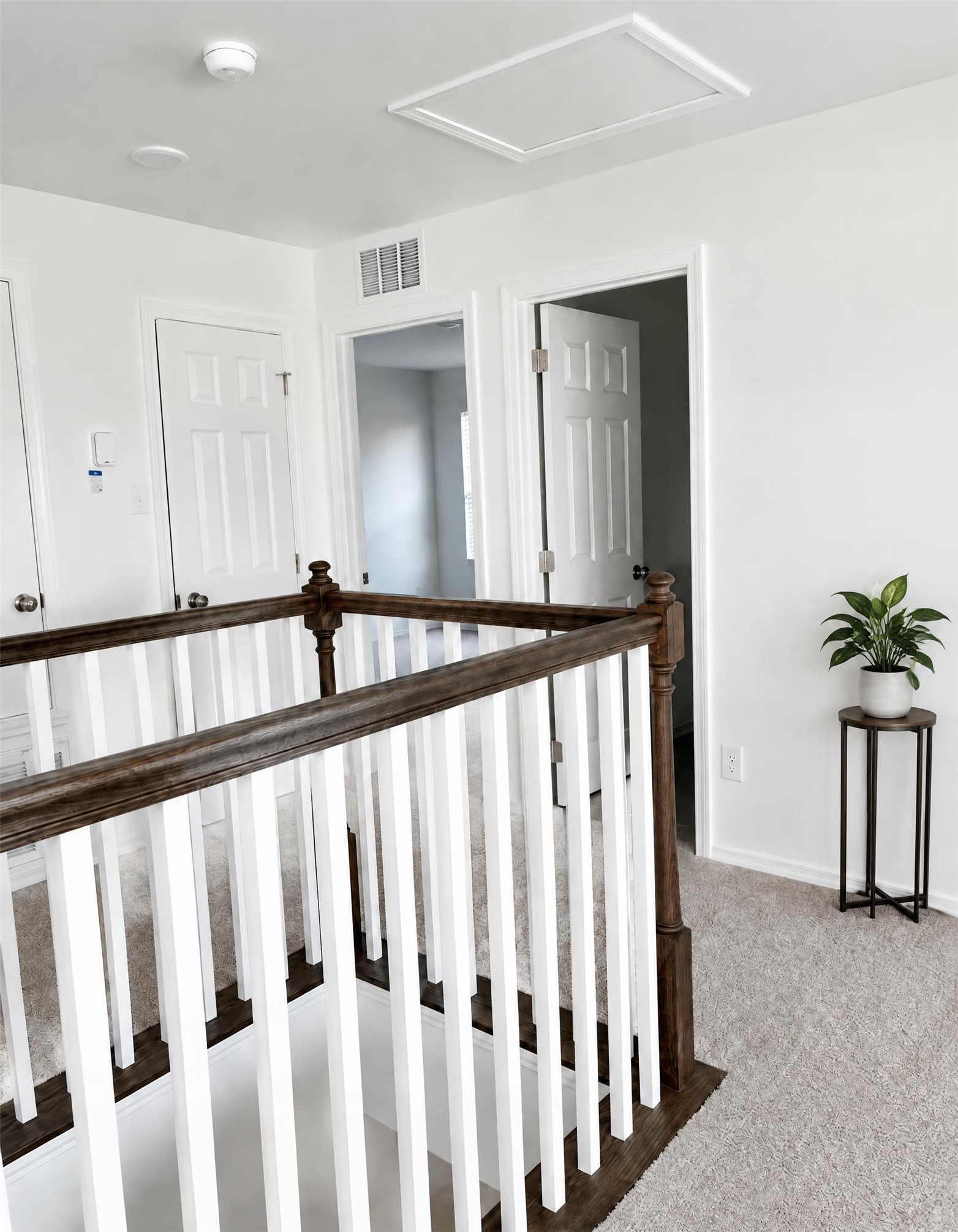 545 Henry Milton Road Georgetown, TX 78626 - Photo 29 of 33 A spacious upper landing features soft carpeting and a wooden banister framing the staircase.
