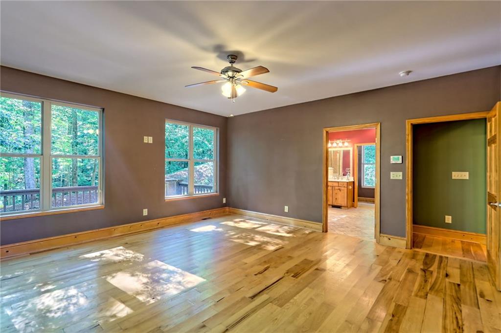 876 Whitetail Trail Clayton, GA 30525 - Photo 31 of 85 a view of an empty room with window and wooden floor