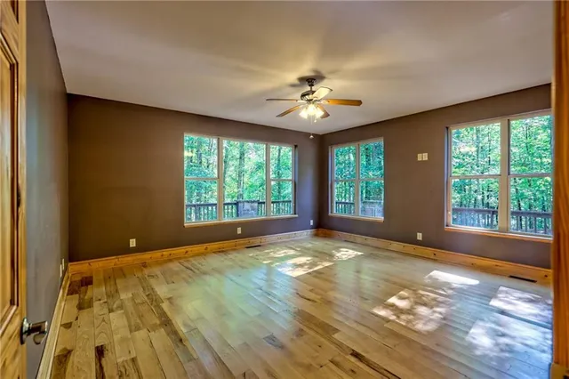 a view of a room with wooden floor and natural light