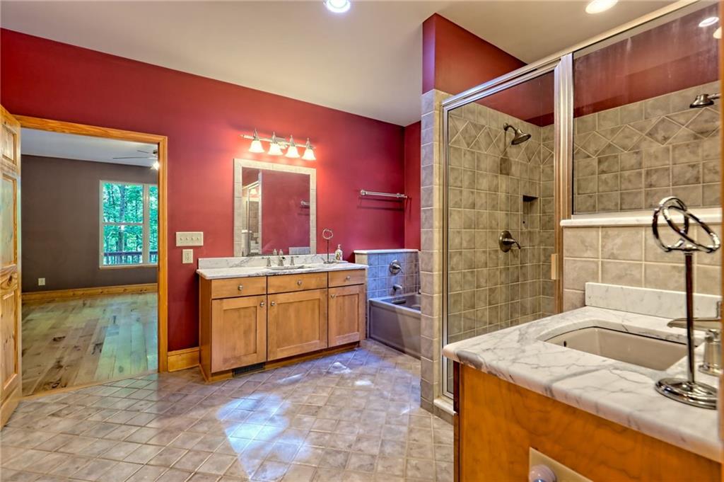 876 Whitetail Trail Clayton, GA 30525 - Photo 34 of 85 a bathroom with a granite countertop sink a mirror and shower