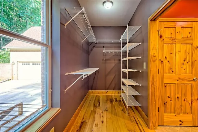 wooden floor in an empty room with a window