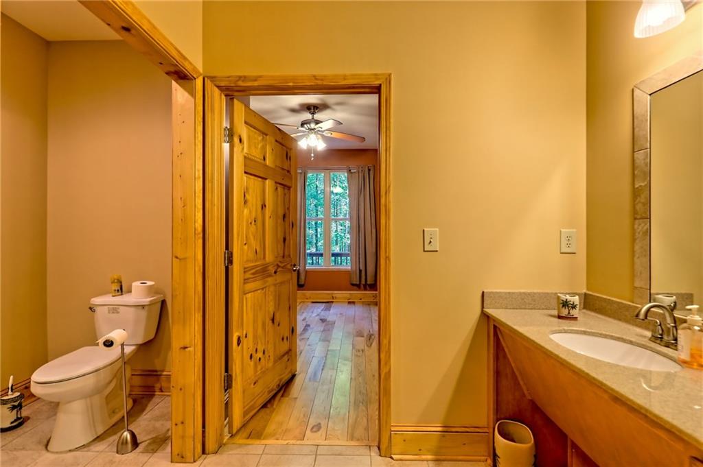 876 Whitetail Trail Clayton, GA 30525 - Photo 40 of 85 a bathroom with a granite countertop sink toilet and shower
