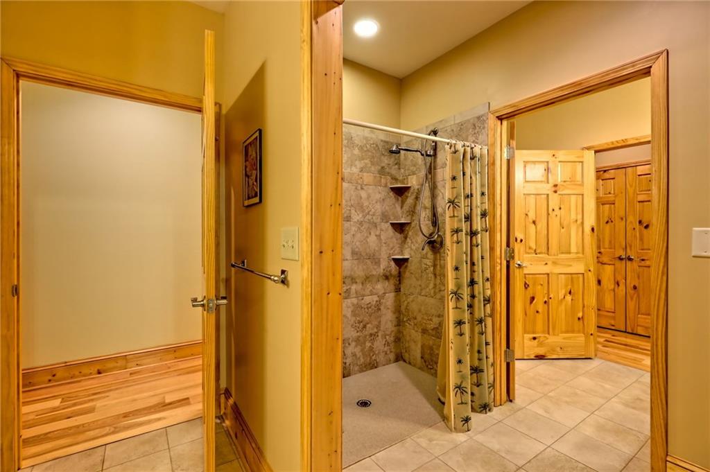 876 Whitetail Trail Clayton, GA 30525 - Photo 41 of 85 a bathroom with a shower and a glass door