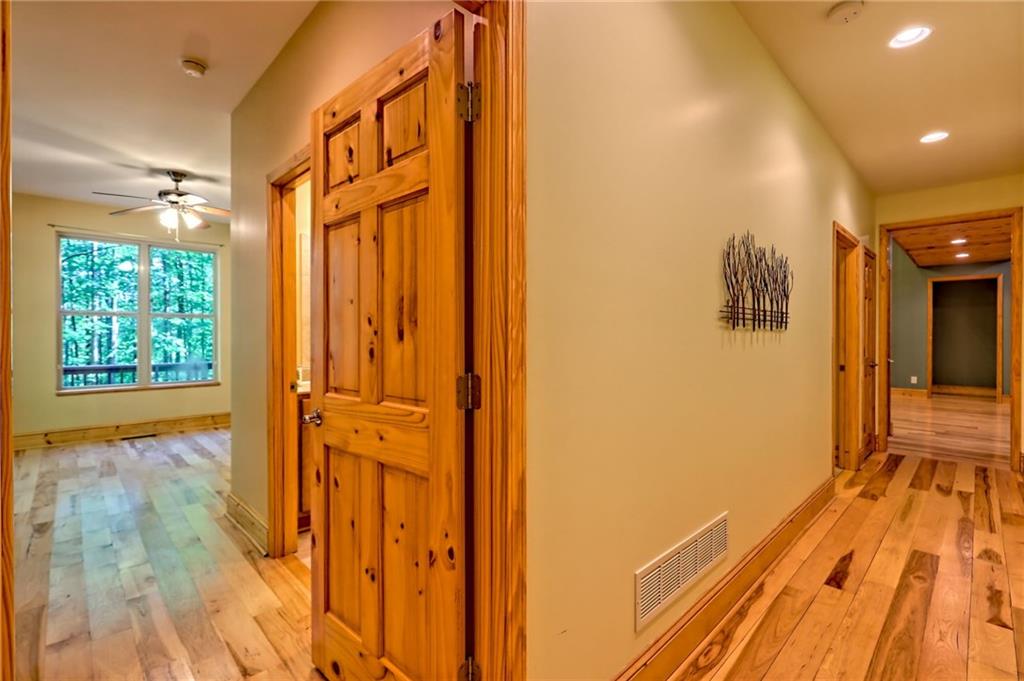 876 Whitetail Trail Clayton, GA 30525 - Photo 50 of 85 a view of a hallway with wooden floor and a bathroom