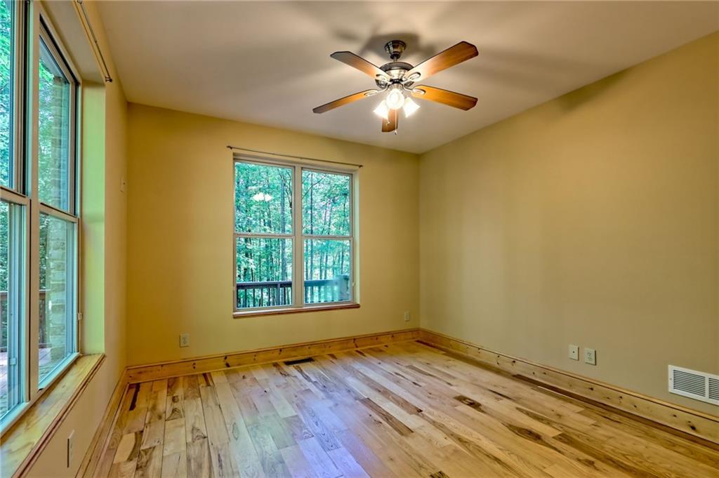 876 Whitetail Trail Clayton, GA 30525 - Photo 51 of 85 an empty room with wooden floor and windows