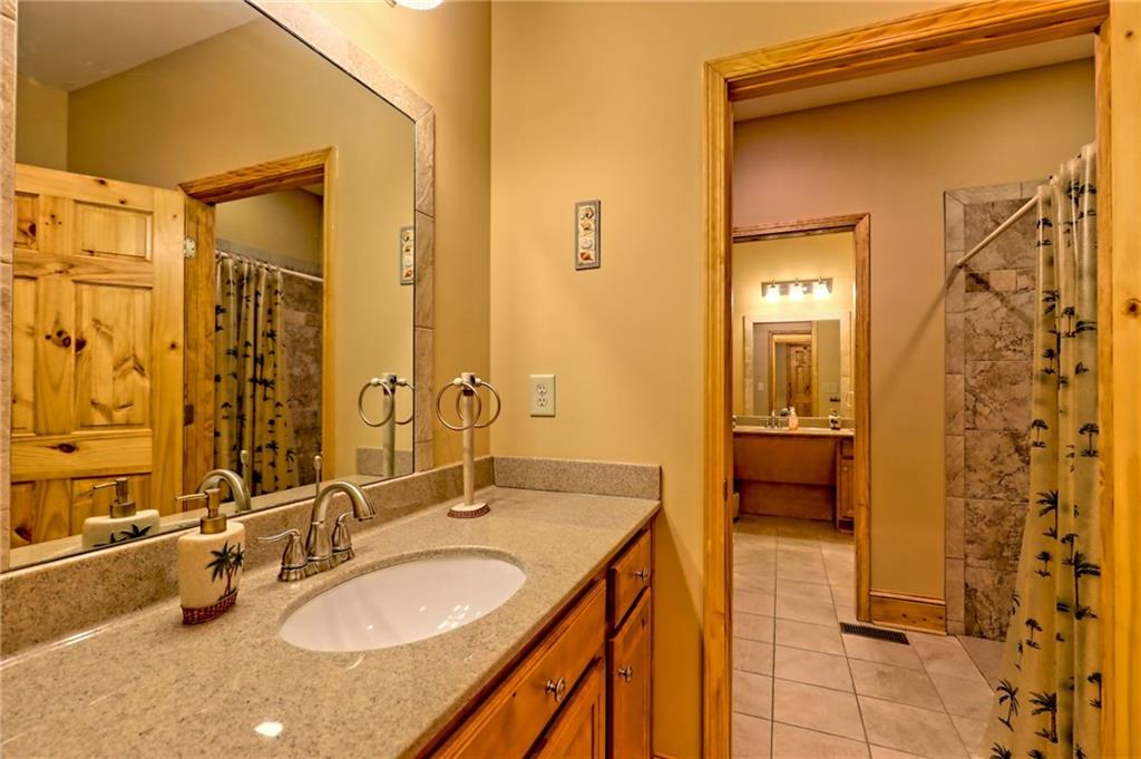 876 Whitetail Trail Clayton, GA 30525 - Photo 53 of 85 a bathroom with a granite countertop sink and a mirror