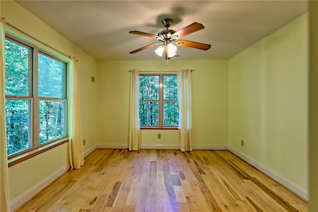 876 Whitetail Trail Clayton, GA 30525 - Photo 59 of 85 a view of an empty room with wooden floor and a window