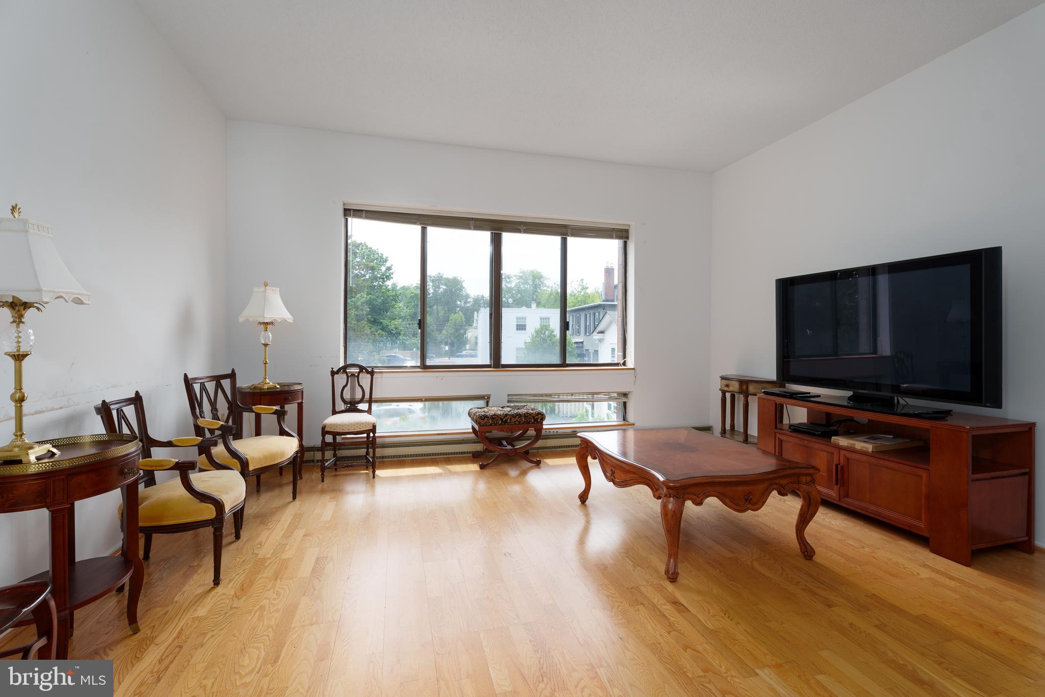 1 Markham Road, Unit 2C Princeton, NJ 08540 - Photo 8 of 23 a living room with furniture and a flat screen tv