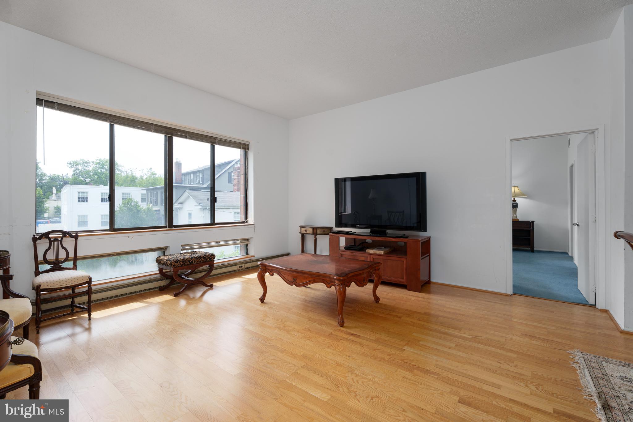 1 Markham Road, Unit 2C Princeton, NJ 08540 - Photo 9 of 23 a living room with furniture and a flat screen tv