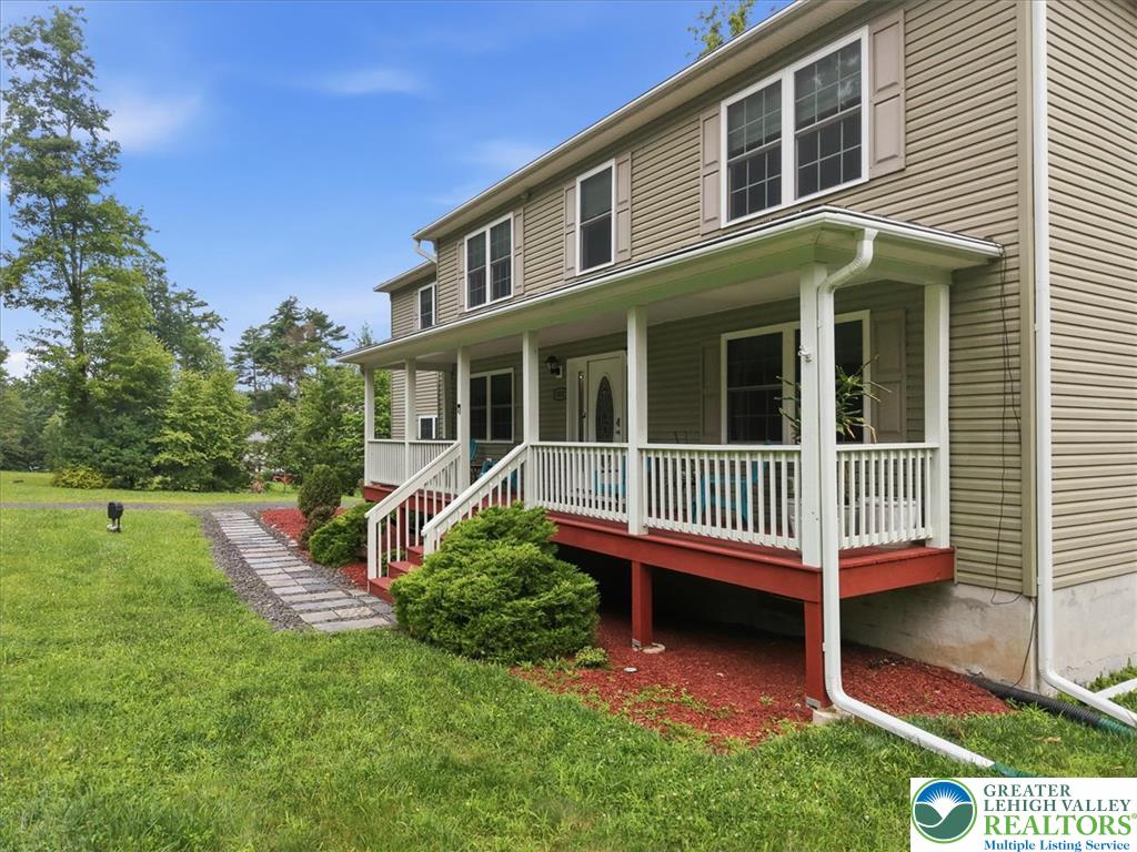 5032 Custard Road Stroudsburg, PA 18360 - Photo 10 of 80 An inviting covered front porch extends across the facade of this two-story home.