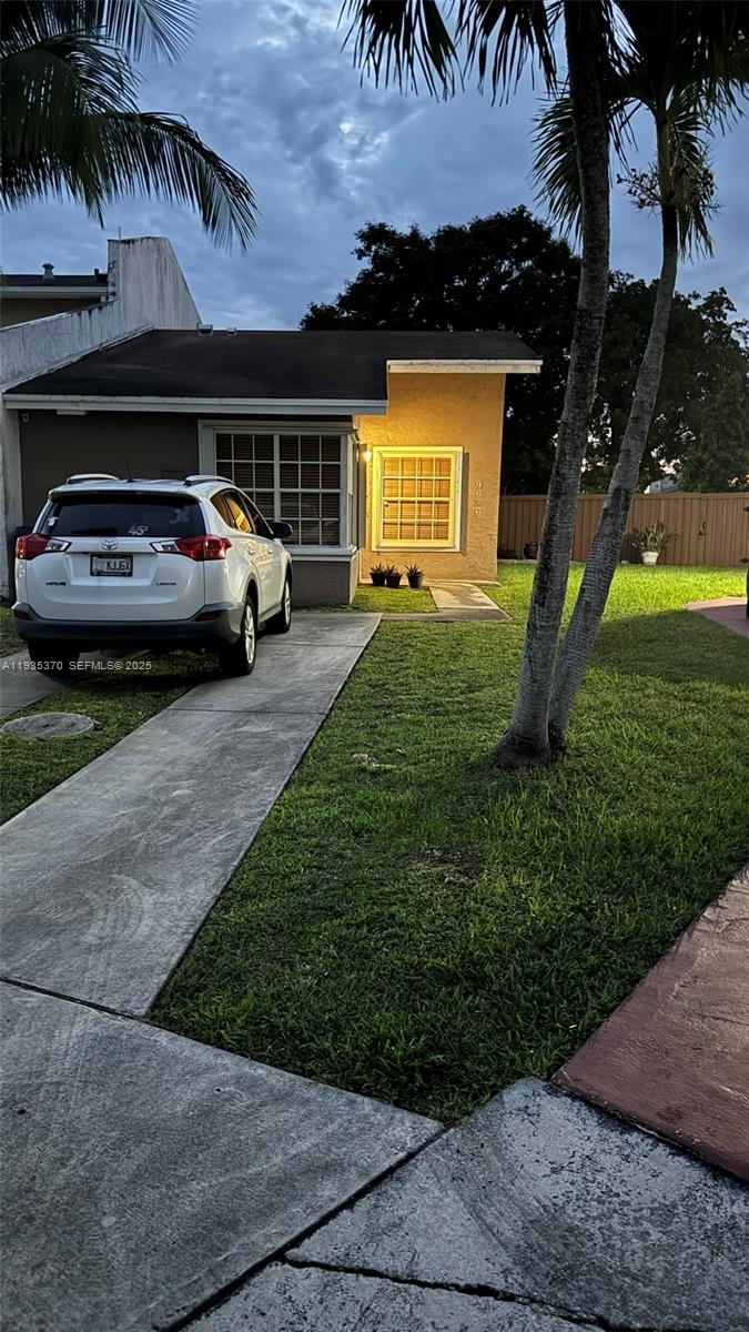 9636 Southwest 147th Court Miami, FL 33196 - Photo 37 of 37 a view of a car parked in front of a house with a yard