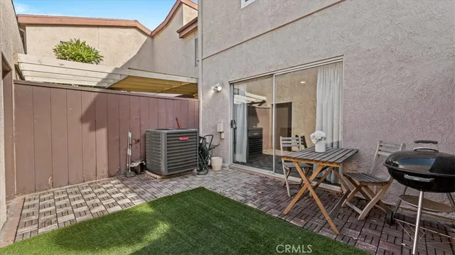 a backyard of a house with table and chairs
