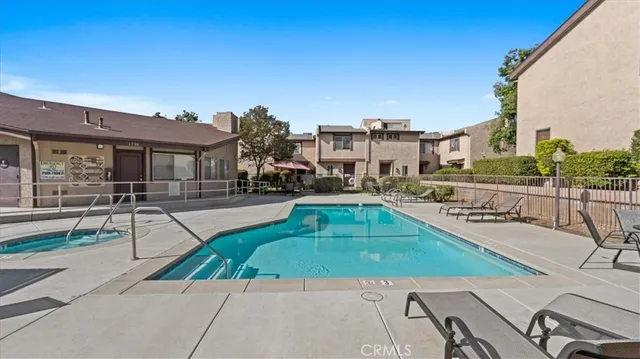 a swimming pool with outdoor seating and yard