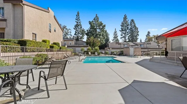 a view of a patio with a table and chairs