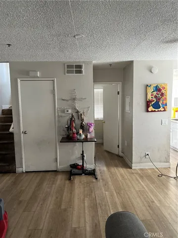 a view of room with workspace and wooden floor