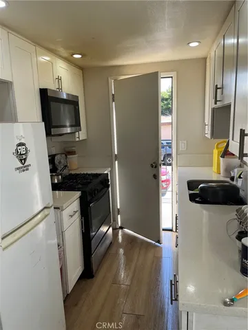 a kitchen with a refrigerator sink and microwave