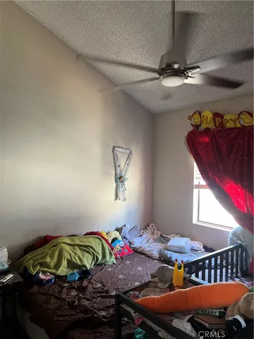 a bedroom with bed and window