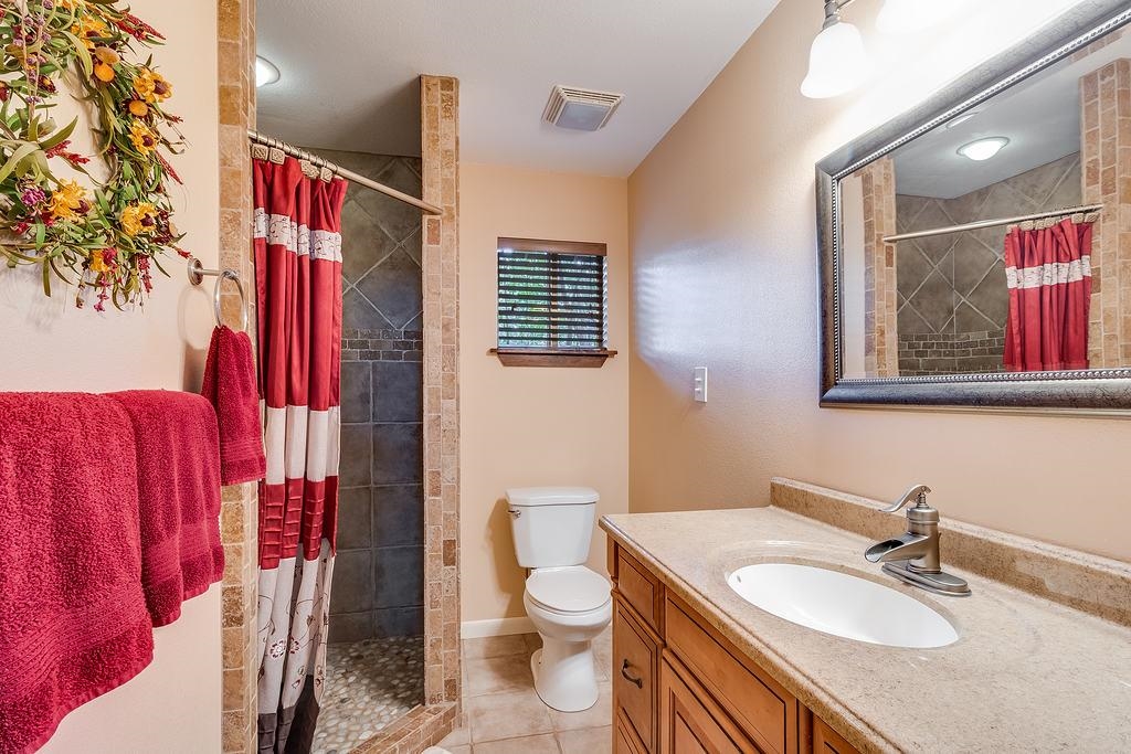 104 Rio Vista Road Burnet, TX 78611 - Photo 14 of 30 a bathroom with a sink toilet and shower