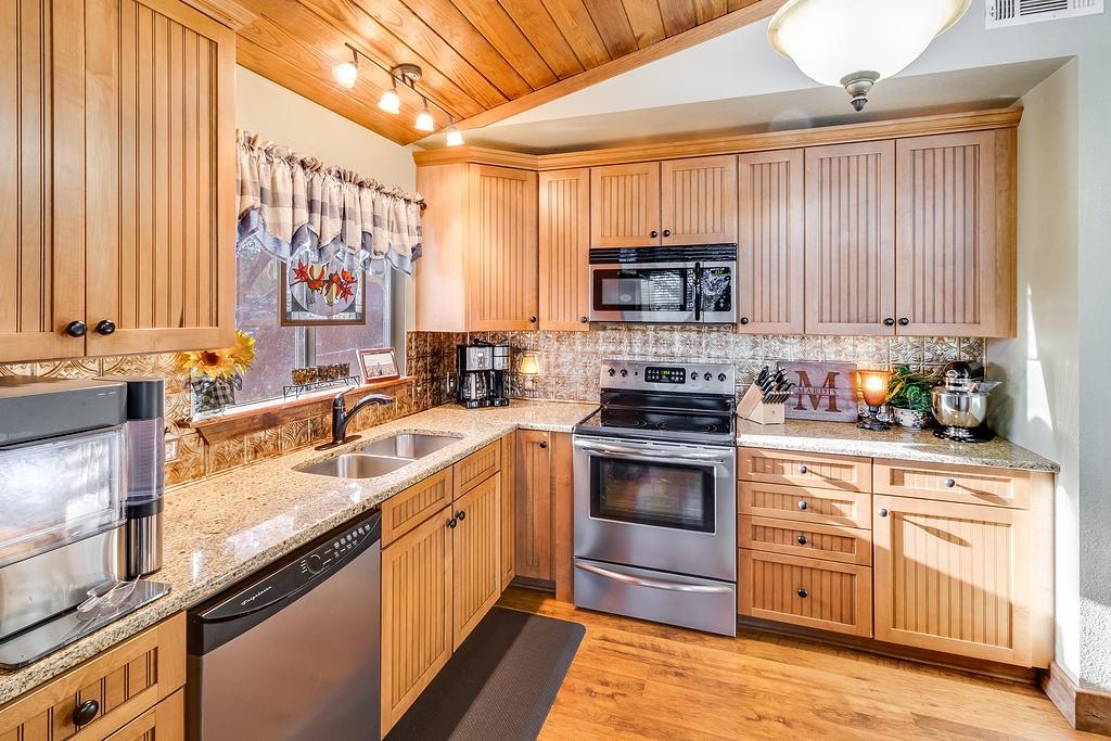 104 Rio Vista Road Burnet, TX 78611 - Photo 17 of 30 a kitchen with a sink stove and microwave
