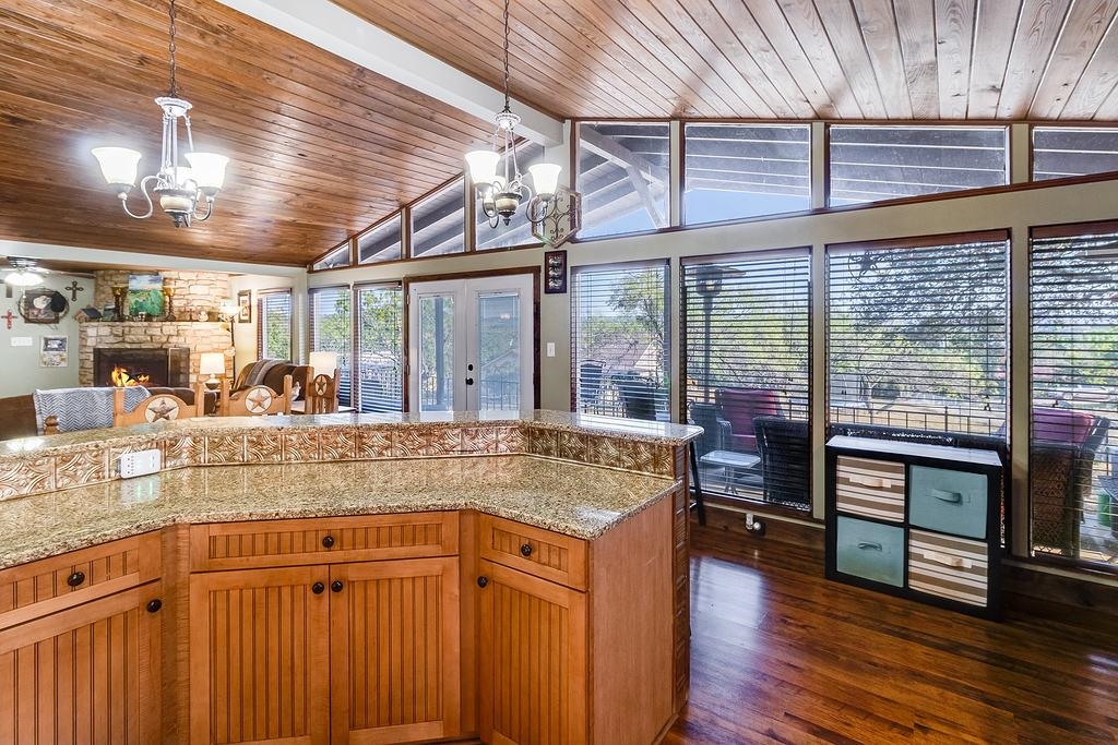 104 Rio Vista Road Burnet, TX 78611 - Photo 18 of 30 a kitchen with stainless steel appliances granite countertop a sink and wooden cabinets