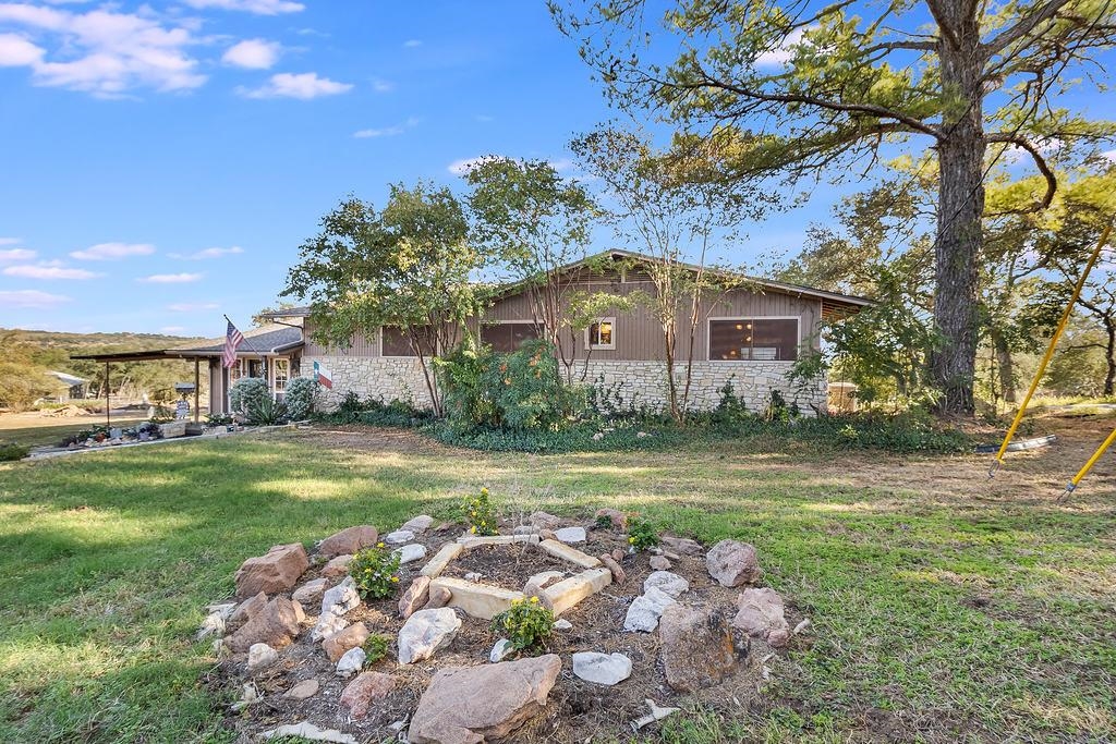 104 Rio Vista Road Burnet, TX 78611 - Photo 3 of 30 a front view of a house with garden