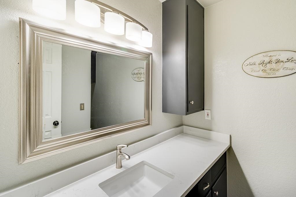 104 Rio Vista Road Burnet, TX 78611 - Photo 10 of 30 a bathroom with a sink and a mirror