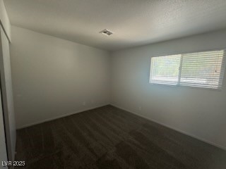 4360 Twin View Circle, Unit 4 Las Vegas, NV 89121 - Photo 11 of 17 Spare room with dark carpet and a textured ceiling