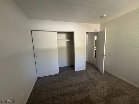 4360 Twin View Circle, Unit 4 Las Vegas, NV 89121 - Photo 12 of 17 Unfurnished bedroom with dark carpet and a closet