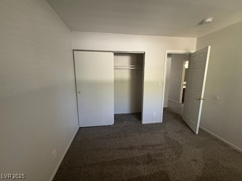 4360 Twin View Circle, Unit 4 Las Vegas, NV 89121 - Photo 13 of 17 Unfurnished bedroom with dark colored carpet and a closet