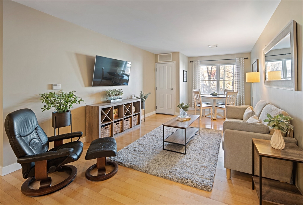 30 Franklin Street, Unit 124 Malden, MA 02148 - Photo 1 of 23 a living room with furniture a flat screen tv and a large window