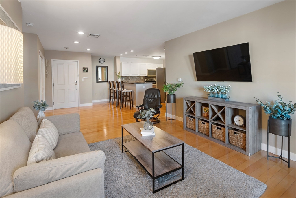 30 Franklin Street, Unit 124 Malden, MA 02148 - Photo 11 of 23 a living room with furniture and a flat screen tv