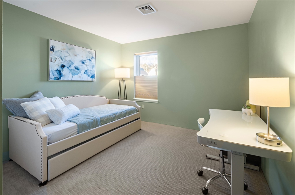 30 Franklin Street, Unit 124 Malden, MA 02148 - Photo 12 of 23 a bedroom with a bed and a desk