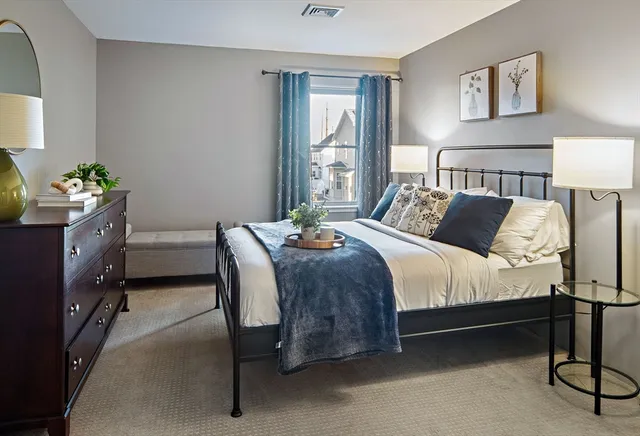 a bedroom with a bed and a dresser