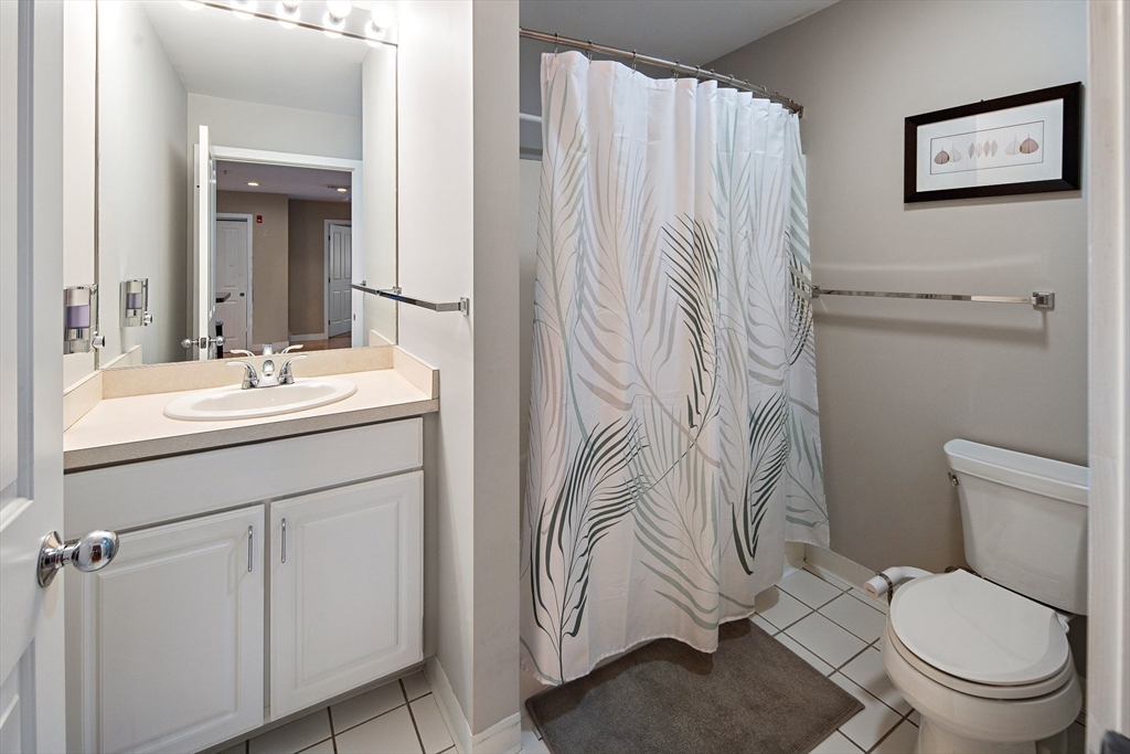 30 Franklin Street, Unit 124 Malden, MA 02148 - Photo 15 of 23 a bathroom with a sink a toilet and a mirror