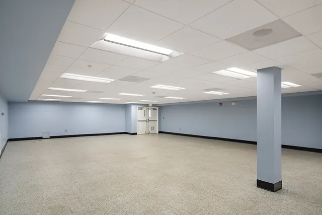 an empty room with a fireplace and window