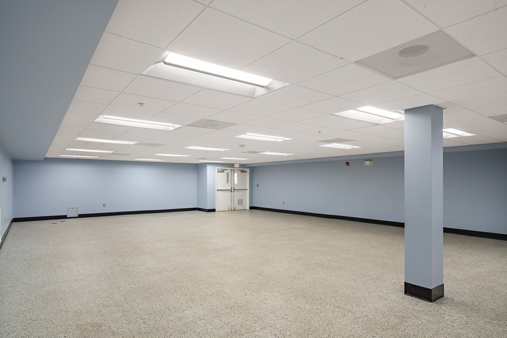 30 Franklin Street, Unit 124 Malden, MA 02148 - Photo 20 of 23 an empty room with a fireplace and window