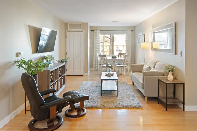 a living room with furniture and wooden floor