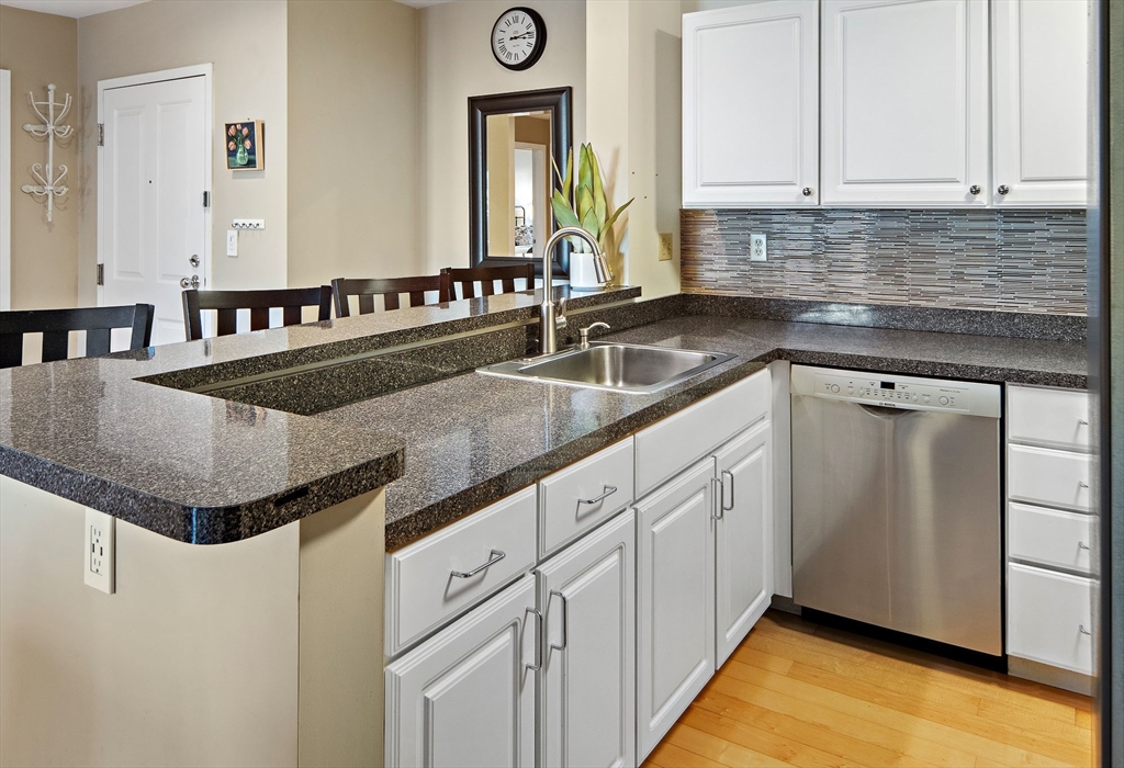 30 Franklin Street, Unit 124 Malden, MA 02148 - Photo 8 of 23 a kitchen with granite countertop a sink and cabinets