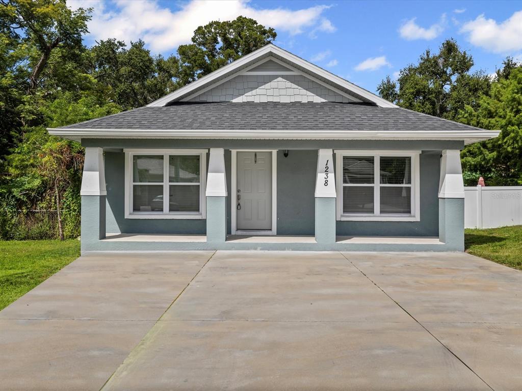 1238 Vista Way Clearwater, FL 33755 - Photo 1 of 32 a front view of a house with a garden