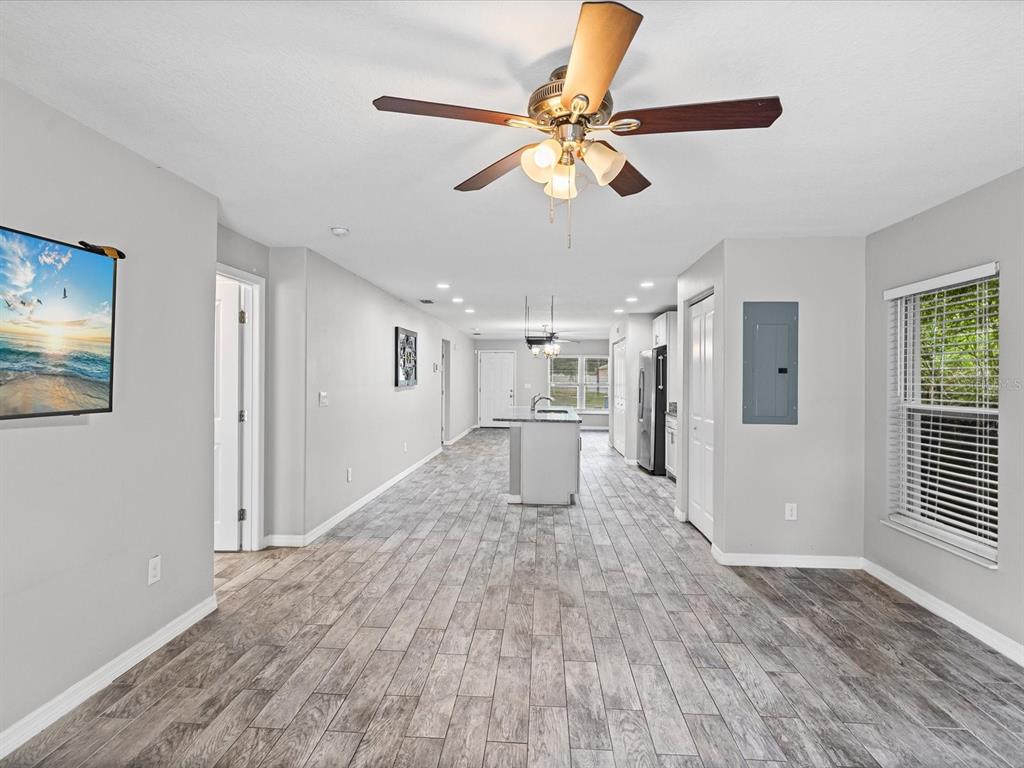 1238 Vista Way Clearwater, FL 33755 - Photo 19 of 32 a view of a livingroom with wooden floor and a ceiling fan