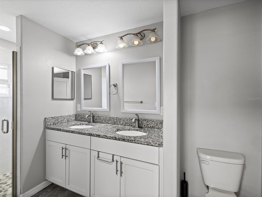 1238 Vista Way Clearwater, FL 33755 - Photo 24 of 32 a bathroom with a granite countertop sink mirror and toilet