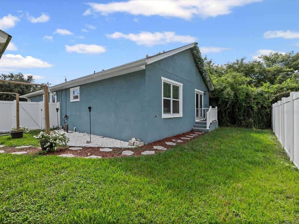 1238 Vista Way Clearwater, FL 33755 - Photo 26 of 32 a backyard of a house with lots of green space