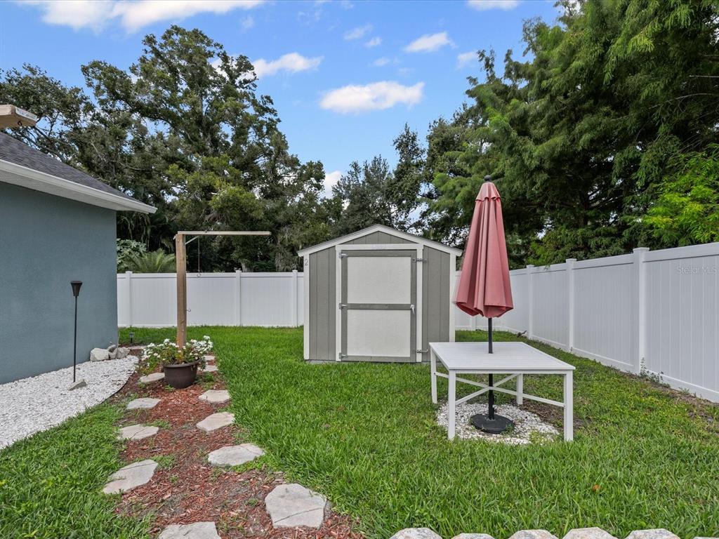 1238 Vista Way Clearwater, FL 33755 - Photo 29 of 32 a view of a chair and table in backyard of the house