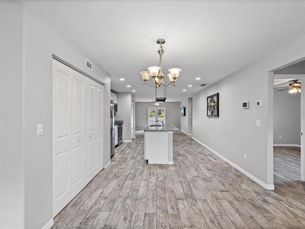 1238 Vista Way Clearwater, FL 33755 - Photo 5 of 32 wooden floor in an empty room with a window