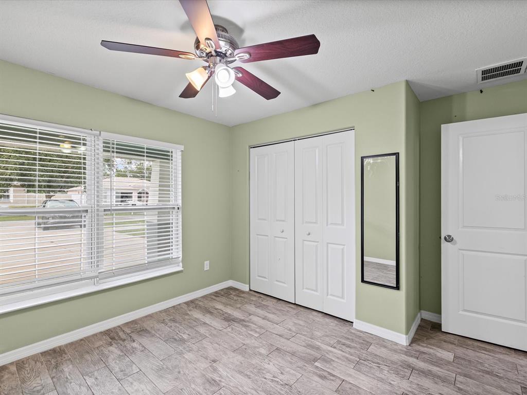 1238 Vista Way Clearwater, FL 33755 - Photo 8 of 32 a view of an empty room with a window and a kitchen