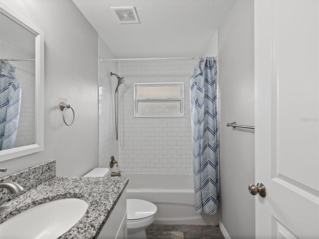 1238 Vista Way Clearwater, FL 33755 - Photo 9 of 32 a bathroom with a granite countertop sink toilet and shower